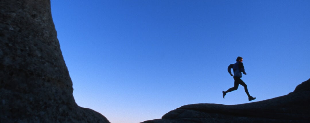 Man running through desert at dusk